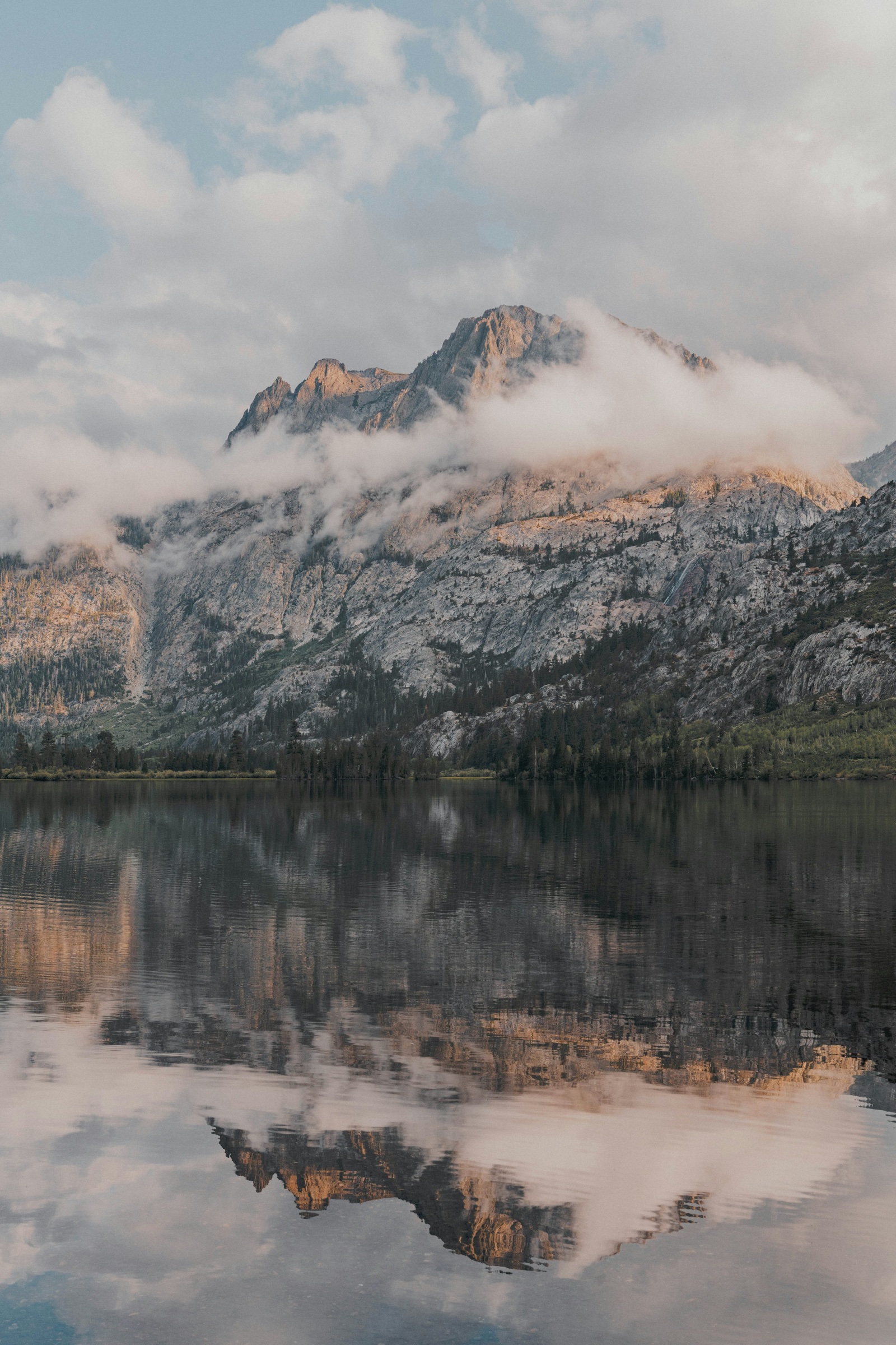 Mountains reflected in the still water of June Lake