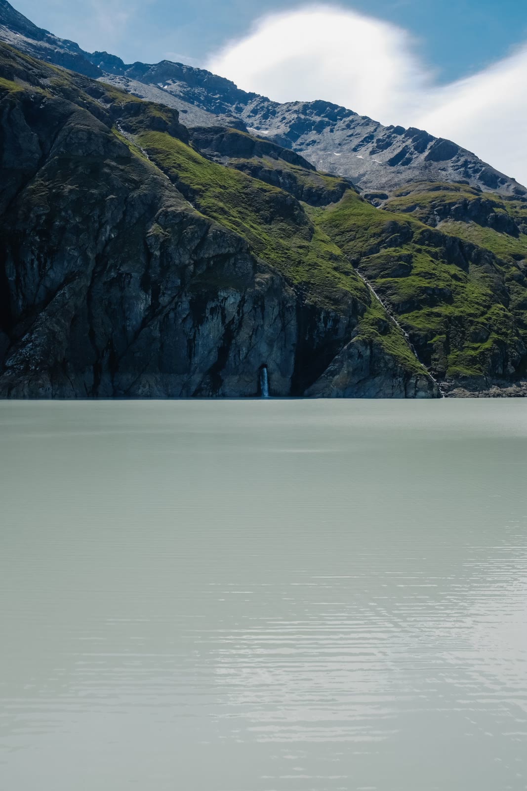 A still lake beneath rocky mountain slopes