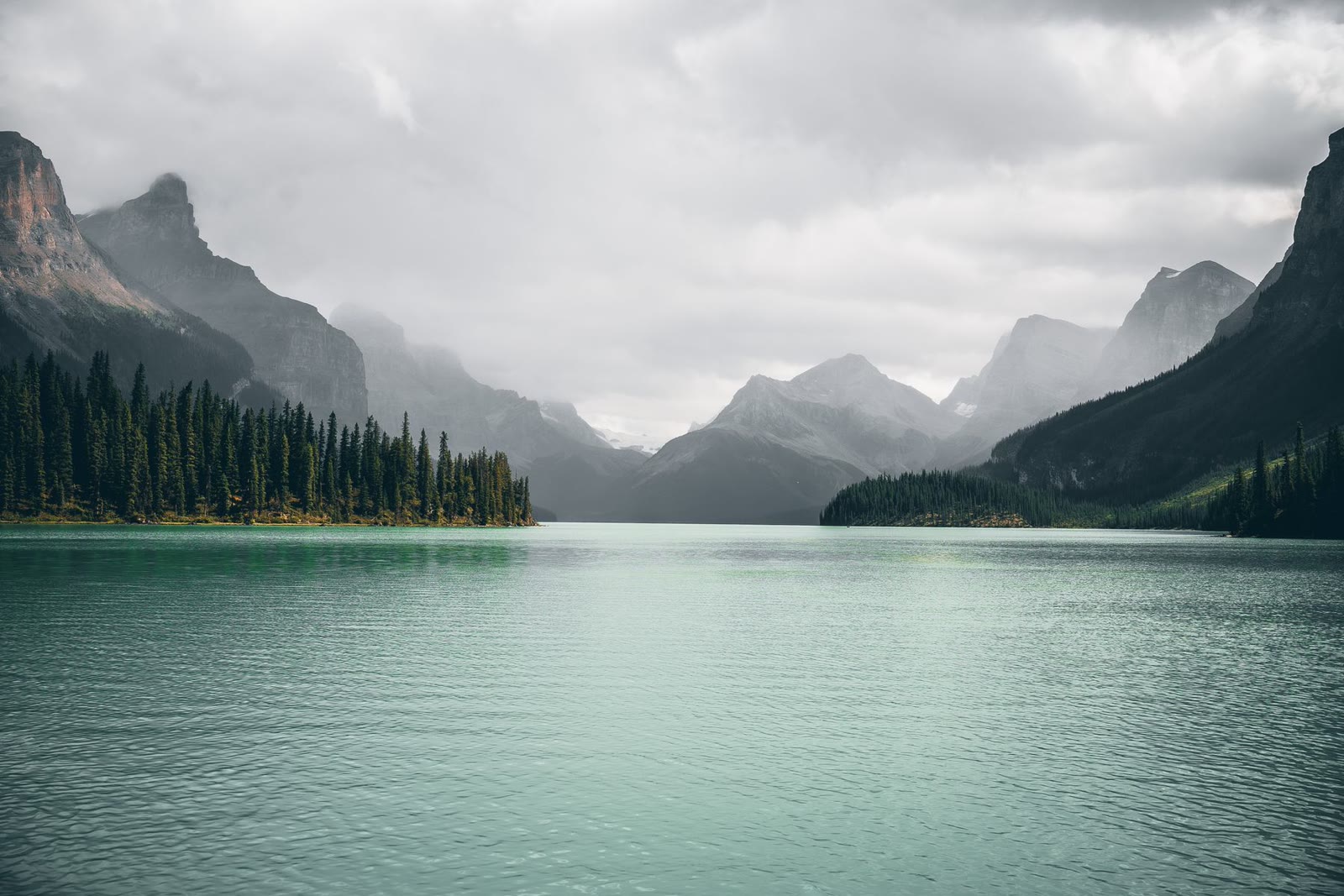 A turquoise lake beneath rugged mountain peaks